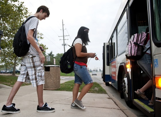 Pioneer junior James Sazyc and others board a bus on the new Ann Arbor Transportation Authority bus route on Waters Road on Tuesday. Daniel Brenner I AnnArbor.com